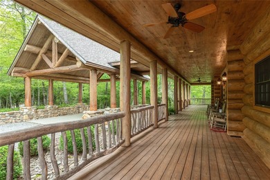 Perched atop over 12 secluded acres, this majestic log cabin - photo 11