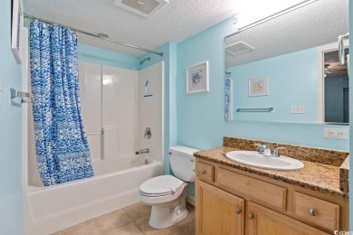 Step right onto the sand from this desirable first-floor, direct