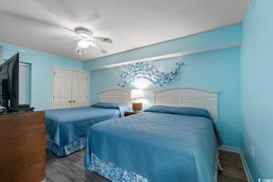 Step right onto the sand from this desirable first-floor, direct