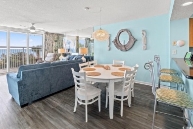 Step right onto the sand from this desirable first-floor, direct