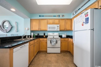 Step right onto the sand from this desirable first-floor, direct