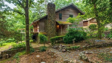 Nestled on 5 private wooded acres, this custom log home offers - photo 1