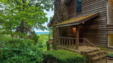 Nestled on 5 private wooded acres, this custom log home offers - photo 3