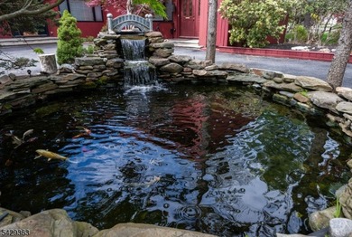 Set on a private and beautifully landscaped .8-acre property - photo 3