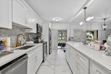 This spacious 2/2 ground-floor condo offers the perfect blend of - photo 1