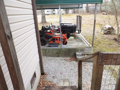 Well-maintained property featuring a 14' RV carport with hookups - photo 26