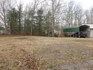 Well-maintained property featuring a 14' RV carport with hookups - photo 27