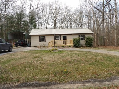 Well-maintained property featuring a 14' RV carport with hookups - photo 28