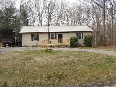 Well-maintained property featuring a 14' RV carport with hookups - photo 29