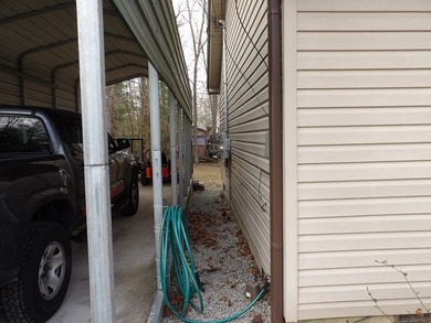 Well-maintained property featuring a 14' RV carport with hookups - photo 31