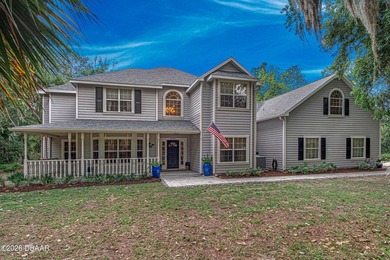 Tucked away on over an acre of beautifully wooded privacy, this - photo 1