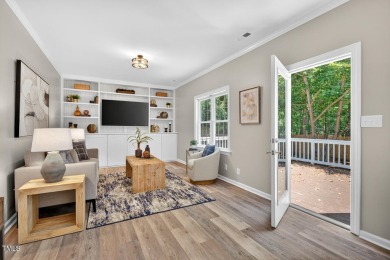 Tucked away on a tree-lined lot with fenced yard, this