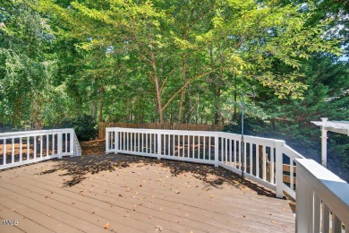 Tucked away on a tree-lined lot with fenced yard, this