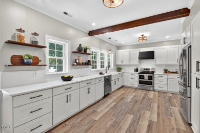 Tucked away on a tree-lined lot with fenced yard, this