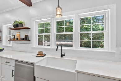 Tucked away on a tree-lined lot with fenced yard, this