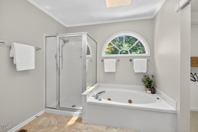 Tucked away on a tree-lined lot with fenced yard, this