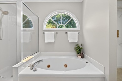 Tucked away on a tree-lined lot with fenced yard, this