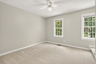 Tucked away on a tree-lined lot with fenced yard, this