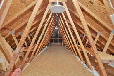 Tucked away on a tree-lined lot with fenced yard, this