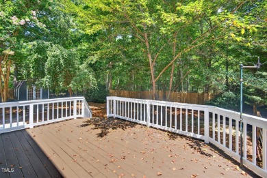 Tucked away on a tree-lined lot with fenced yard, this