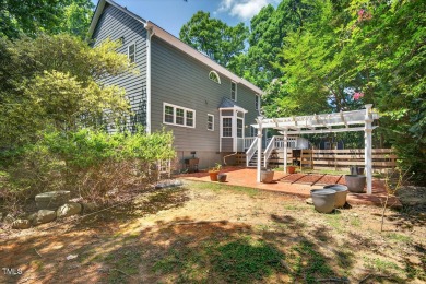 Tucked away on a tree-lined lot with fenced yard, this