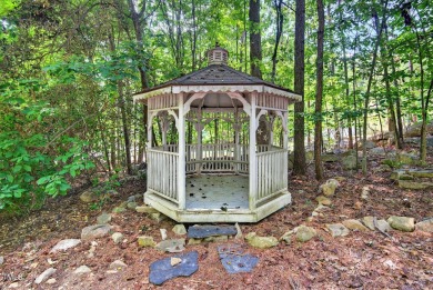 Tucked away on a tree-lined lot with fenced yard, this