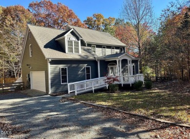 Tucked away on a tree-lined lot with fenced yard, this