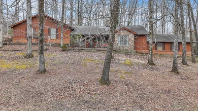 Nestled on a hill, this charming 4-bedroom, 2.5-bath home is - photo 1