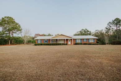 This classic ranch-style home sits gracefully on 62 sprawling - photo 2