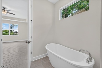 HOME IS COMPLETED!!! Long canal views, dual primary suites, a - photo 8