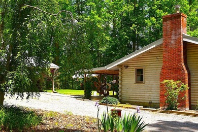 Nestled in the woods on a peaceful 3.169-acre lot, this inviting - photo 1