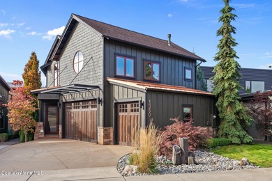 Nestled along the Spokane River in the highly sought-after gated