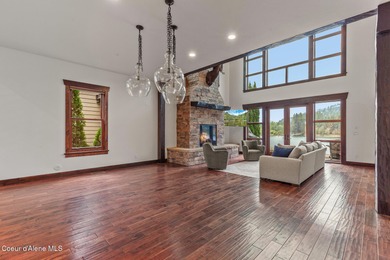 Nestled along the Spokane River in the highly sought-after gated