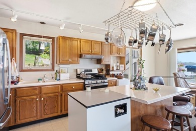 This charming two-story home sits right on the water's edge of - photo 10