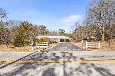 Discover the potential of this beautiful four-sided brick ranch