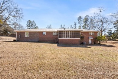 Discover the potential of this beautiful four-sided brick ranch