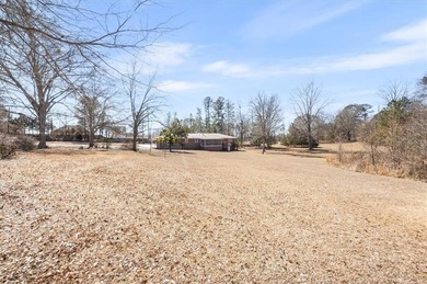 Discover the potential of this beautiful four-sided brick ranch