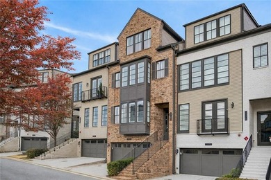 Experience elevated townhome living in the prestigious Gates at