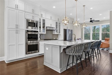 Experience elevated townhome living in the prestigious Gates at