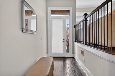 Experience elevated townhome living in the prestigious Gates at