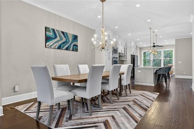 Experience elevated townhome living in the prestigious Gates at