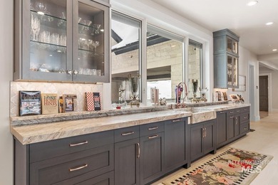 Built for entertaining, the kitchen features stunning mirrored - photo 18