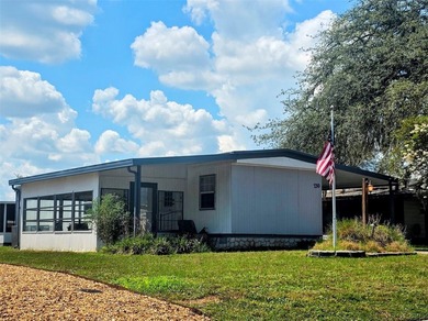This manufactured home sits on owned land in The Villages. No - photo 2
