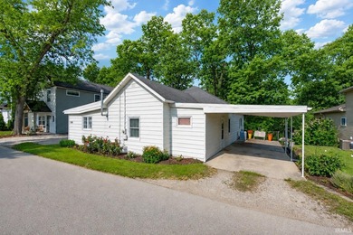 Tucked into a peaceful setting with mature trees and open green - photo 1