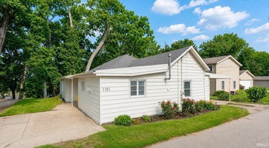 Tucked into a peaceful setting with mature trees and open green - photo 2