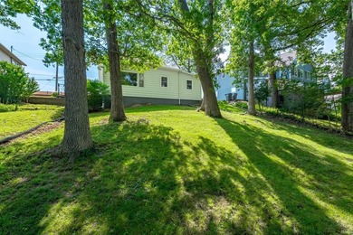 Tucked into a peaceful setting with mature trees and open green - photo 4