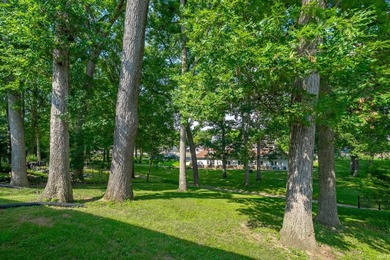 Tucked into a peaceful setting with mature trees and open green - photo 5