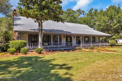 Set on 2.36 acres shaded by beautiful oak trees, this Gulfport - photo 2