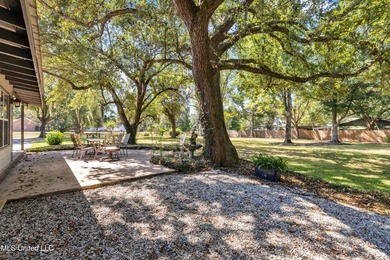 Set on 2.36 acres shaded by beautiful oak trees, this Gulfport - photo 3