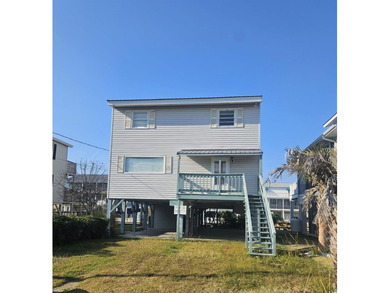 Don't miss this 3BR/2BA raised beach home tucked away on quiet - photo 1